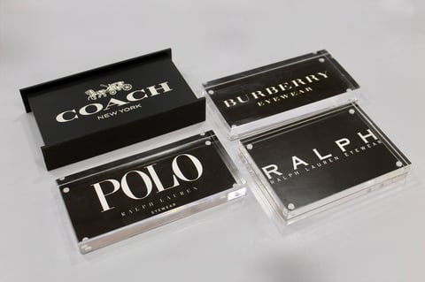 Four luxury brand nameplates displayed